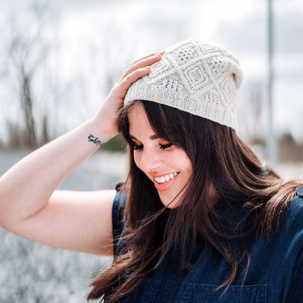 White beanie knitting pattern with geometric modern cables