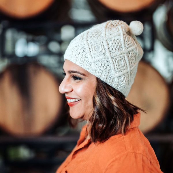 White beanie knitting pattern with geometric modern cables