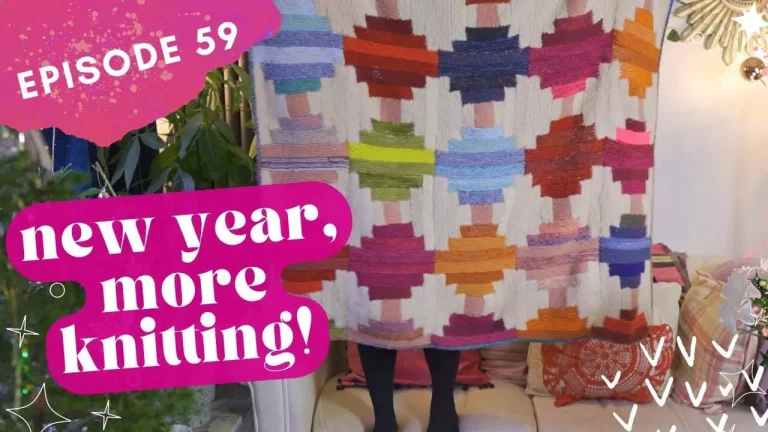 Thumbnail for The Crimson Stitchery knitting video showing a woman standing on a sofa holding up a large, colourful handknitted blanket, and text reading New Year More Knitting